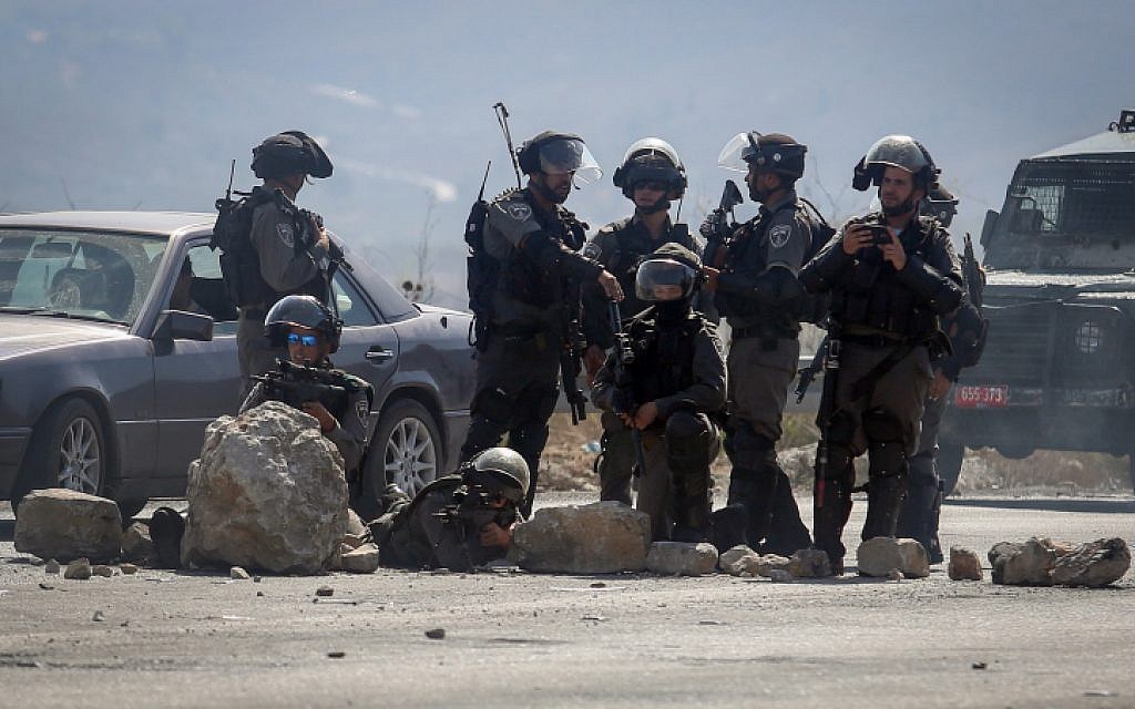 Israeli security forces keep position during clashes with Palestinian protesters at the Hawara checkpoint, south of the West Bank city of Nablus, on October 11, 2015. (Flash90) Israeli security forces keep position during clashes with Palestinian protesters at the Hawara checkpoint, south of the West Bank city of Nablus, on October 11, 2015. (Flash90)