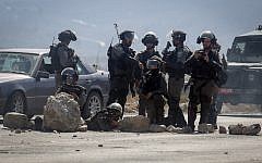 Israeli security forces keep position during clashes with Palestinian protesters at the Hawara checkpoint, south of the West Bank city of Nablus, on October 11, 2015. (Flash90)