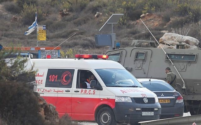 Illustrative: Israeli security forces and a Palestinian Red Crescent ambulance at the Tapuah junction near the West Bank city of Nablus, October 30, 2015. (Flash90) Illustrative: Israeli security forces and a Palestinian Red Crescent ambulance at the Tapuah junction near the West Bank city of Nablus, October 30, 2015. (Flash90)