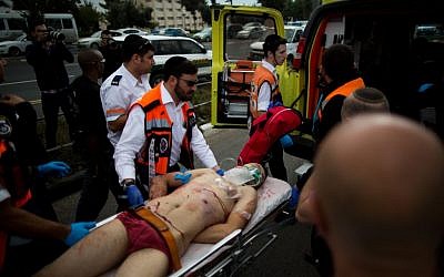 Israeli medics evacuate a Palestinian terrorist after he  stabbed two people in an attack near the Ammunition Hill light rail station in Jerusalem, October 30, 2015. Yonatan Sindel/Flash90)