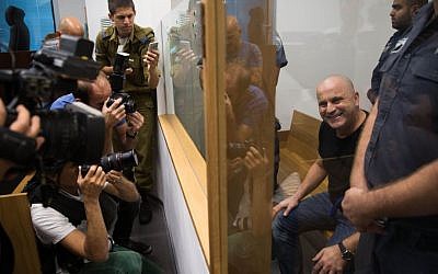 Crime boss Rico Shirazi smiles at photographers at the Tel Aviv District Court on November 02, 2015. (Nati Shohat/Flash90)