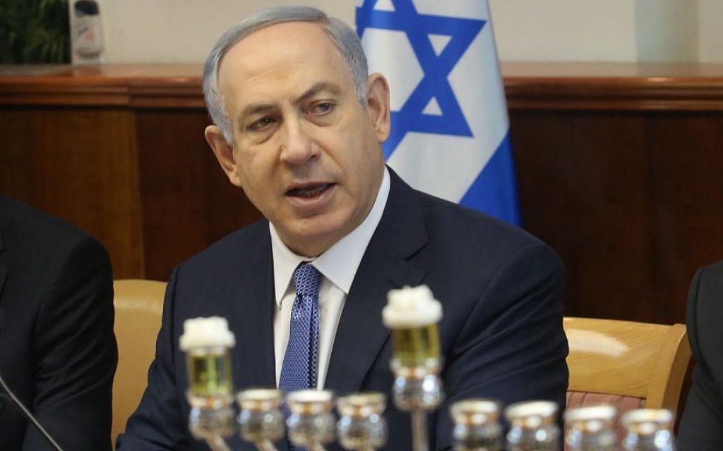 Prime Minister Benjamin Netanyahu speaks at the start of the weekly cabinet meeting in Jerusalem, next to a menorah ready for the first night of the Jewish holiday of Hanukkah, December 6, 2015 (Emil Salman/Haaretz)