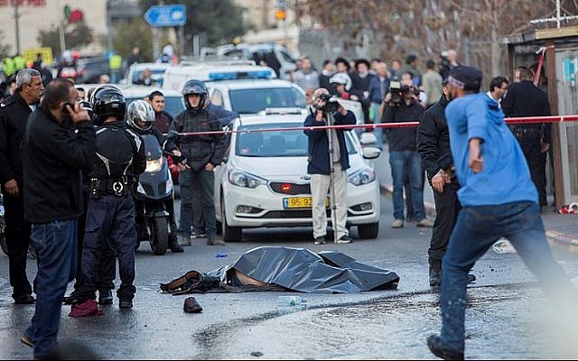 The body of a Palestinian terrorist lies in the road after he was shot dead by Israeli security personnel during a terror attack at the entrance to Jerusalem on December 14, 2015, that injured 14 people, including a baby. (Photo by Yonatan Sindel/Flash90) The body of a Palestinian terrorist lies in the road after he was shot dead by Israeli security personnel during a terror attack at the entrance to Jerusalem on December 14, 2015, that injured 14 people, including a baby. (Photo by Yonatan Sindel/Flash90)