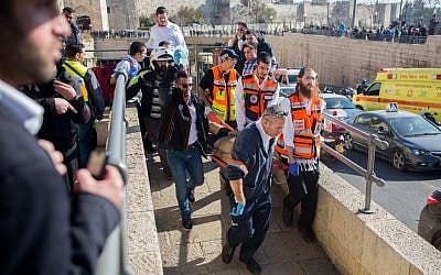 Rescue and medical personnel carrying a wounded man at the scene of a stabbing attack at the Old City’s Jaffa Gate in Jerusalem on December 23, 2015. (Yonatan Sindel/Flash90)