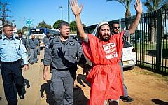 A right-wing Jewish activist protests outside a court hearing in Petah Tikva, December 28, 2015, on the matter of the Jewish youths arrested for involvement in an arson attack in the West Bank village of Duma, earlier this summer,  in which three members of the Dawabshe family were killed. (Photo by Flash90)