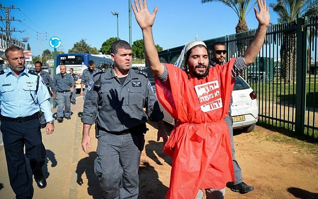 A right-wing Jewish activist protests outside a court hearing in Petah Tikva, December 28, 2015, on the matter of the Jewish youths arrested for involvement in an arson attack in the West Bank village of Duma, earlier this summer, in which three members of the Dawabshe family were killed. (Photo by Flash90) A right-wing Jewish activist protests outside a court hearing in Petah Tikva, December 28, 2015, on the matter of the Jewish youths arrested for involvement in an arson attack in the West Bank village of Duma, earlier this summer, in which three members of the Dawabshe family were killed. (Photo by Flash90)