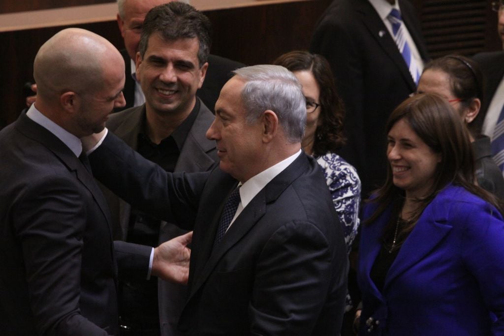 New Likud MK Amir Ohana is congratulated by Prime Minister Benjamin Netanyahu after his swearing-in, on December 28, 2015. (Isaac Harari/FLASH90) New Likud MK Amir Ohana is congratulated by Prime Minister Benjamin Netanyahu after his swearing-in, on December 28, 2015. (Isaac Harari/FLASH90)