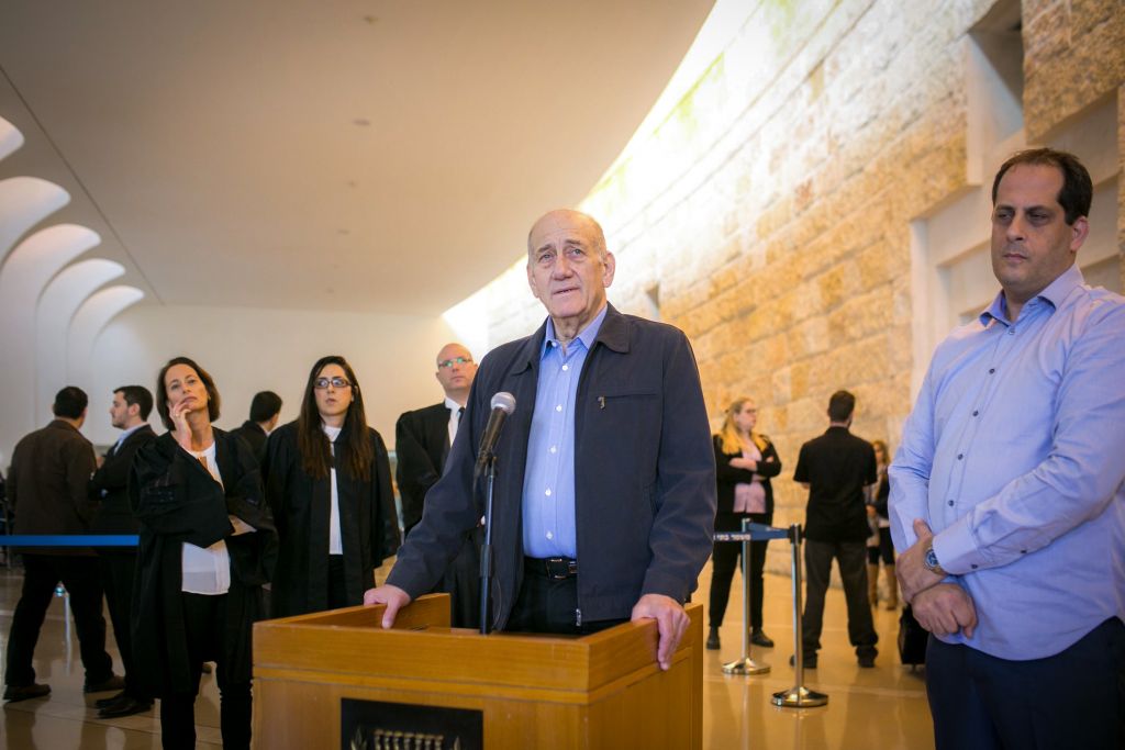 Former prime minister Ehud Olmert speaks to the press at the Jerusalem Supreme Court on December 29, 2015. The court reduced Olmert's sentence to 18 months, following a conviction on corruption charges in the Holyland affair. (Noam Moskowitz/POOL) Former prime minister Ehud Olmert speaks to the press at the Jerusalem Supreme Court on December 29, 2015. The court reduced Olmert's sentence to 18 months, following a conviction on corruption charges in the Holyland affair. (Noam Moskowitz/POOL)