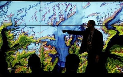 People attend a climate conference at the US pavilion during the COP21, United Nations Climate Change Conference in Le Bourget, north of Paris, Thursday, Dec. 10, 2015. (AP Photo/Christophe Ena)