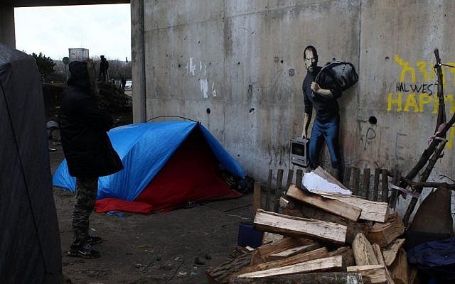 A painting by English graffiti artist Banksy is seen at the entrance of the Calais refugee camp in France, Saturday, Dec. 12, 2015. (AP Photo/Michel Spingler) A painting by English graffiti artist Banksy is seen at the entrance of the Calais refugee camp in France, Saturday, Dec. 12, 2015. (AP Photo/Michel Spingler)