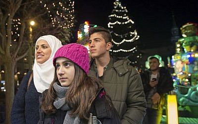 Illustrative: Syrian refugees Reem Habashieh, Raghad Habashieh, Yaman Habashieh and Mohammed Habashieh, from left to right, visit the Christmas market in Zwickau, eastern Germany on  Tuesday, Dec. 8, 2015. (AP Photo/Jens Meyer)