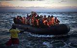 Refugees and migrants arrive on a dinghy from the Turkish coast to the Greek island of Lesbos, Friday, Dec. 18, 2015. (AP Photo/Santi Palacios)