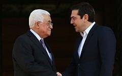 Greek Prime Minister Alexis Tsipras, right, shakes hands with President of the Palestinian Authority Mahmoud Abbas before their meeting in Athens,  December 21, 2015. (AP/Petros Giannakouris)