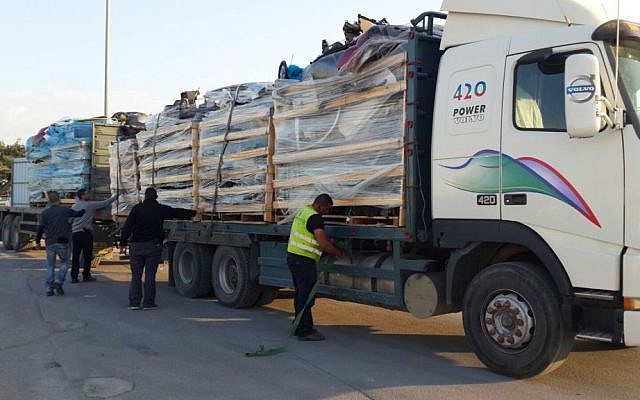 A Defense Ministry employee discovers bulletproof plating in a shipment of car parts on its way to the Gaza Strip through the Kerem Shalom Crossing on December 29, 2015. (Defense Ministry)