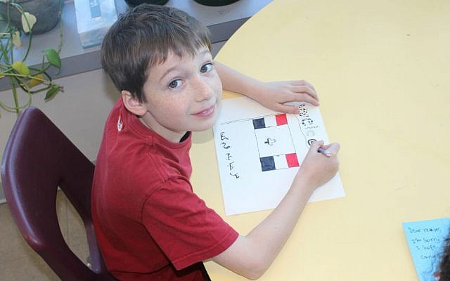 A student at Paul Penna Downtown Jewish Day School in Toronto, Canada incorporates the Syrian and Canadian flags, as well as Arabic in his card welcoming Syrian refugees. (Courtesy)