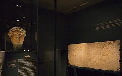 A bronze head of Roman Emperor Hadrian from the Louvre with a monumental inscription at an Israel Museum exhibit opening December 22, 2015. (Moti Tufeld)
