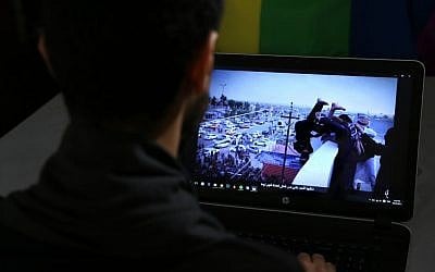 In this Oct. 22, 2015, photo, Daniel Halaby, a gay Syrian living in southern Turkey, shows a photo from his laptop of Islamic State group militants throwing a man off a roof for allegedly violating the extremists' ban on homosexuality. Halaby told The Associated Press that even two years after fleeing to Turkey to escape IS, he wakes up from nightmares that he has been captured and is about to be thrown off a building. (AP Photo/Hussein Malla)