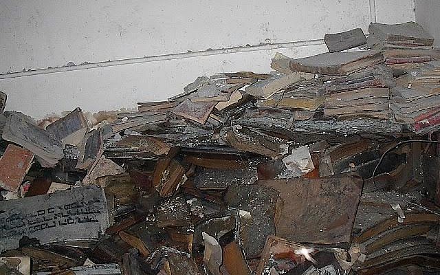 Waterlogged books from the Jewish community of Iraq are shown after their rescue from the flooded basement headquarters of Saddam Hussein's secret police on May 6, 2003, Baghdad, Iraq. (Coutesy: Harold Rhode)