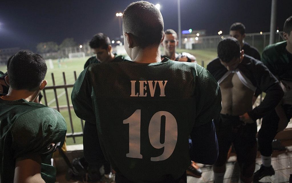 High school football team Kfar Saba Hawks players warm up for a game against Mazkeret Batya Gorillas in Kfar Saba, Israel, December 10, 2015. (Photo by AP Photo/Dan Balilty)