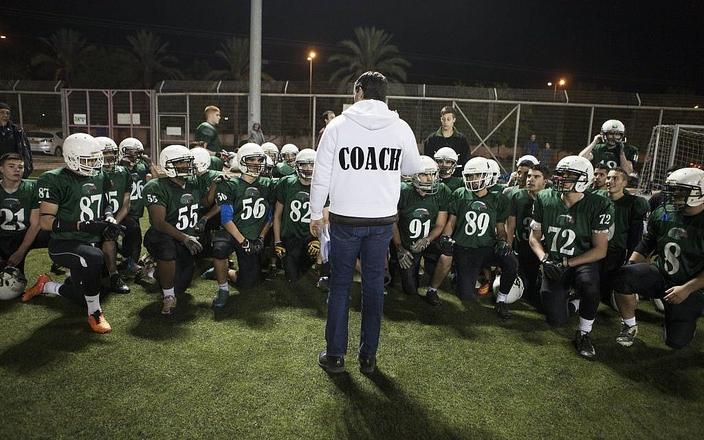 High school football team Kfar Saba Hawks players warm up for a game against Mazkeret Batya Gorillas in Kfar Saba, Israel, December 10, 2015. (Photo by AP Photo/Dan Balilty)