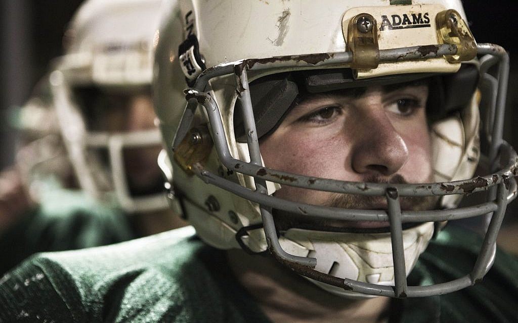 A member of the high school football team Kfar Saba Hawks, in the game against Mazkeret Batya Gorillas in Kfar Saba, December 10, 2015. (AP/Dan Balilty)