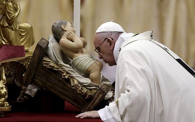 Pope Francis kisses a statue of Baby Jesus as he celebrates the Christmas Eve Mass in St. Peter's Basilica in the Vatican, December 24, 2015. (AP/Gregorio Borgia) Pope Francis kisses a statue of Baby Jesus as he celebrates the Christmas Eve Mass in St. Peter's Basilica in the Vatican, December 24, 2015. (AP/Gregorio Borgia)