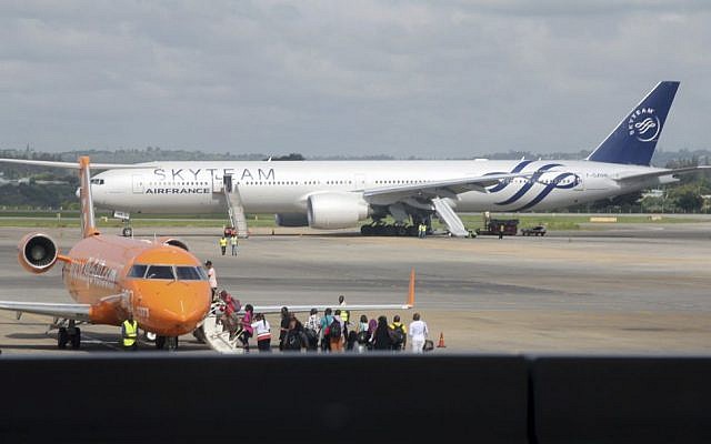 An Air France plane which made an emergency landing is seen behind passengers boarding on a small jetliner at Moi International Airport in Mombasa, Kenya Sunday, December 20, 2015. (AP/Edwin Kana) An Air France plane which made an emergency landing is seen behind passengers boarding on a small jetliner at Moi International Airport in Mombasa, Kenya Sunday, December 20, 2015. (AP/Edwin Kana)
