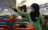 In this Dec. 22, 2015, photo, a Rayani Air flight crew demonstrates a safety brief before departure at the Sultan Ismail Petra Airport in Kelantan, Malaysia.  (AP Photo/Joshua Paul)