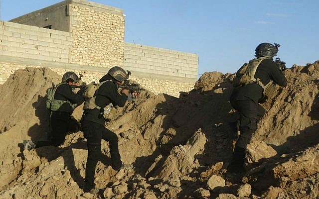 Iraqi security forces take combat positions at the front line with Islamic State as Iraqi Army and allied Sunni volunteer tribal fighters supported by US-led coalition airstrikes are tightening the siege of Ramadi, the capital of Iraq's Anbar province, 70 miles (115 kilometers) west of Baghdad, Iraq, Monday, Nov. 30, 2015. (AP Photo/Osama Sami)