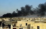 In this Friday, Dec. 25, 2015 photo, smoke rises from Islamic State positions following a US-led coalition airstrike as Iraqi security forces advance their position in downtown Ramadi, 70 miles (115 kilometers) west of Baghdad, Iraq. (AP Photo)