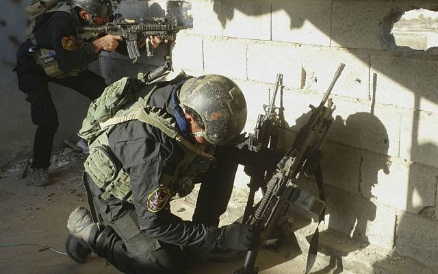Iraqi security forces take combat positions at the front line with Islamic State fighters as Iraqi Army and allied Sunni volunteer tribal fighters supported by US-led coalition airstrikes tighten the siege of Ramadi, the capital of Iraq's Anbar province, 70 miles (115 kilometers) west of Baghdad, Iraq, Monday, Nov. 30, 2015. (AP Photo/Osama Sami)