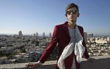 In this Wednesday, Dec. 9, 2015 photo, Iranian poet Payam Feili poses for a photograph in Tel Aviv, Israel. (AP Photo/Dan Balilty)