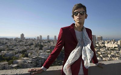 In this Wednesday, Dec. 9, 2015 photo, Iranian poet Payam Feili poses for a photograph in Tel Aviv, Israel. (AP Photo/Dan Balilty)