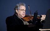 In this Wednesday, Dec. 10, 2010 file photo, Itzhak Perlman plays the violin during the National Menorah lighting in celebration of Hanukkah near the White House in Washington.  (AP Photo/Evan Vucci, File)
