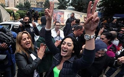Families of soldiers and policemen who were kidnapped by militants from the Islamic State group and al-Qaida's branch in Syria, the Nusra Front, cheer after following news that their sons were being released, in front of tents set up for a protest in downtown Beirut, Lebanon, Tuesday, Dec. 1, 2015. (AP Photo/Bilal Hussein)