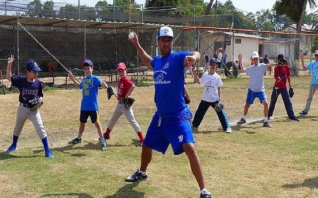 Nate Fish, director of the Israel Association of Baseball, demonstrating pitching to Israeli kids. (Margo Sugarman/IAB) Nate Fish, director of the Israel Association of Baseball, demonstrating pitching to Israeli kids. (Margo Sugarman/IAB)