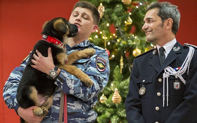 A Russian police officer holds a puppy, named Dobrynya, as a French police officer smiles before presenting the puppy to French police in the French Embassy in Moscow, Russia, Monday, December 7, 2015. (AP/Pavel Golovkin) A Russian police officer holds a puppy, named Dobrynya, as a French police officer smiles before presenting the puppy to French police in the French Embassy in Moscow, Russia, Monday, December 7, 2015. (AP/Pavel Golovkin)