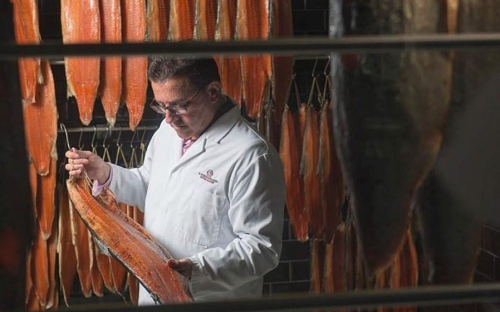 CEO Lance Forman examines a salmon fillet at Forman and Sons headquarters. (courtesy)
