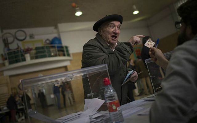 An old man casts his vote at a polling station in Pamplona, northern Spain, Sunday, Dec. 20, 2015. (AP Photo/Alvaro Barrientos)