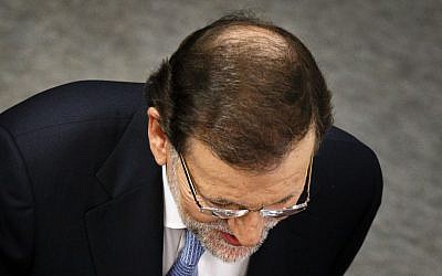 Spain's Prime Minister and Popular Party candidate Mariano Rajoy arrives at a TV studio before the start of a live televised debate with Socialist Party candidate Pedro Sanchez, in Madrid, Spain, Monday, Dec. 14, 2015. (AP Photo/Daniel Ochoa de Olza)