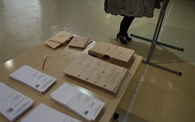 A woman votes in a cubicle at polling station for the national elections, in Pamplona northern Spain, Sunday, Dec. 20, 2015. (AP Photo/Alvaro Barrientos)