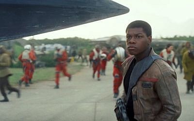 This photo provided by Disney shows John Boyega as Finn, in a scene from the new film, "Star Wars: The Force Awakens," directed by J.J. Abrams. (Film Frame/Disney/Lucasfilm via AP)