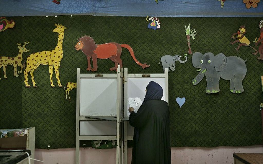 In this Sunday, Nov. 22, 2015 file photo, a woman reads a ballot inside a polling station for women during the second phase of the parliamentary elections in Qalyoubiya governorate, north of Cairo, Egypt. (AP Photo/Nariman El-Mofty, File) In this Sunday, Nov. 22, 2015 file photo, a woman reads a ballot inside a polling station for women during the second phase of the parliamentary elections in Qalyoubiya governorate, north of Cairo, Egypt. (AP Photo/Nariman El-Mofty, File)