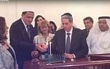Rabbi Moshe Levin lights Hanukkah candles in Bahrain with French Imam Hassan Chalghoumi, on December 8 2015. (Screen capture YouTube)