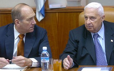 Prime minister Ariel Sharon sits beside Ehud Olmert at a cabinet meeting in the Prime Minister's office, September 26, 2004 (Sharon Perry/Flash 90)