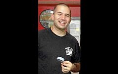 This photo provided by Arlene Wagner and taken in October 2015 shows her son, Air Force Staff Sgt. Peter Taub, killed December 21, 2015 in a suicide attack in Afghanistan, at Bub and Pops, the sandwich shop Wagner and her other son Jonathan Taub run in downtown Washington, DC. (Arlene Wagner/AP)