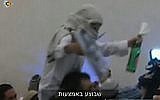 A far-right Israeli wedding-goer celebrates the murder of the Dawabsha family (screen capture: Channel 10)