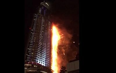 A fire that broke out in a building near a massive New Year's Eve fireworks display in Dubai, December 31, 2015 (YouTube screen cap)