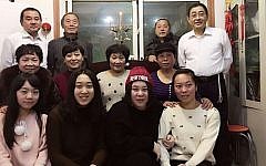 Some members of China's Jewish community in Kaifeng on the first night of Hanukkah, December 6, 2015. (Shavei Israel)