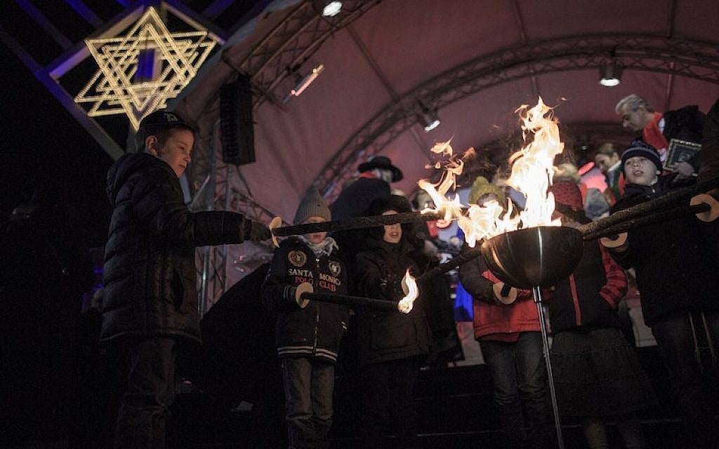 Children light torches at the ceremony of the Hanukkah menorah lighting at a public Menorah ceremony near the Brandenburg Gate on December 6, 2015 in Berlin, Germany. (Carsten Koall/Getty Images) Children light torches at the ceremony of the Hanukkah menorah lighting at a public Menorah ceremony near the Brandenburg Gate on December 6, 2015 in Berlin, Germany. (Carsten Koall/Getty Images)
